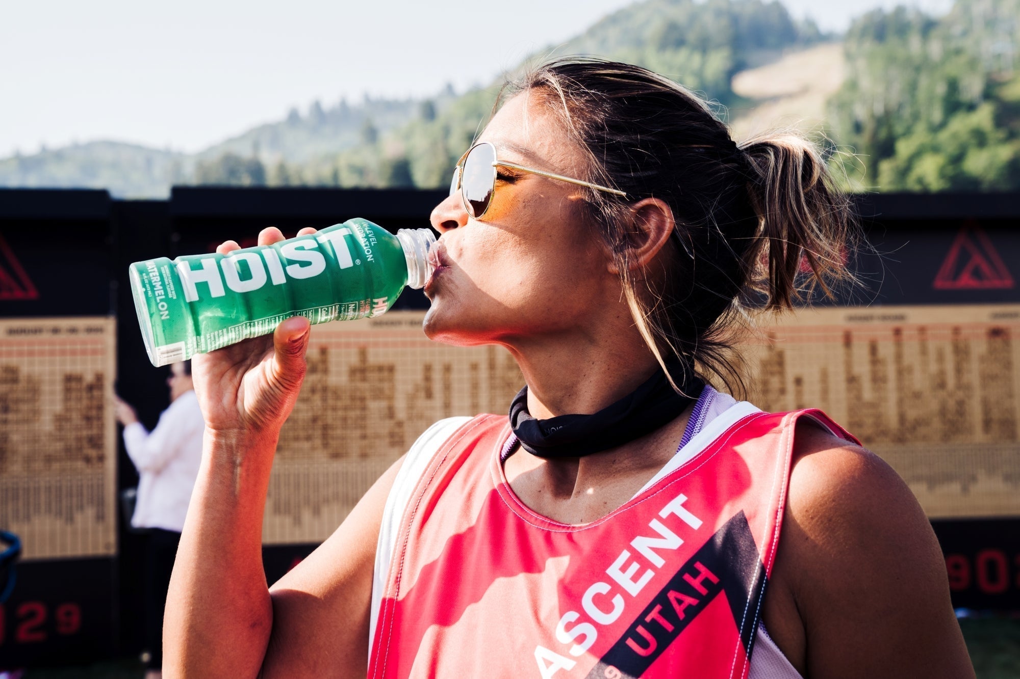 Woman drinking a Hoist Electrolyte Beverage