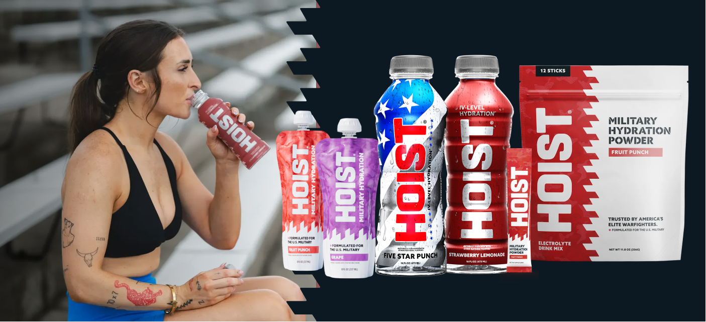 Woman drinking from a Hoist energy drink container with various Hoist products displayed.