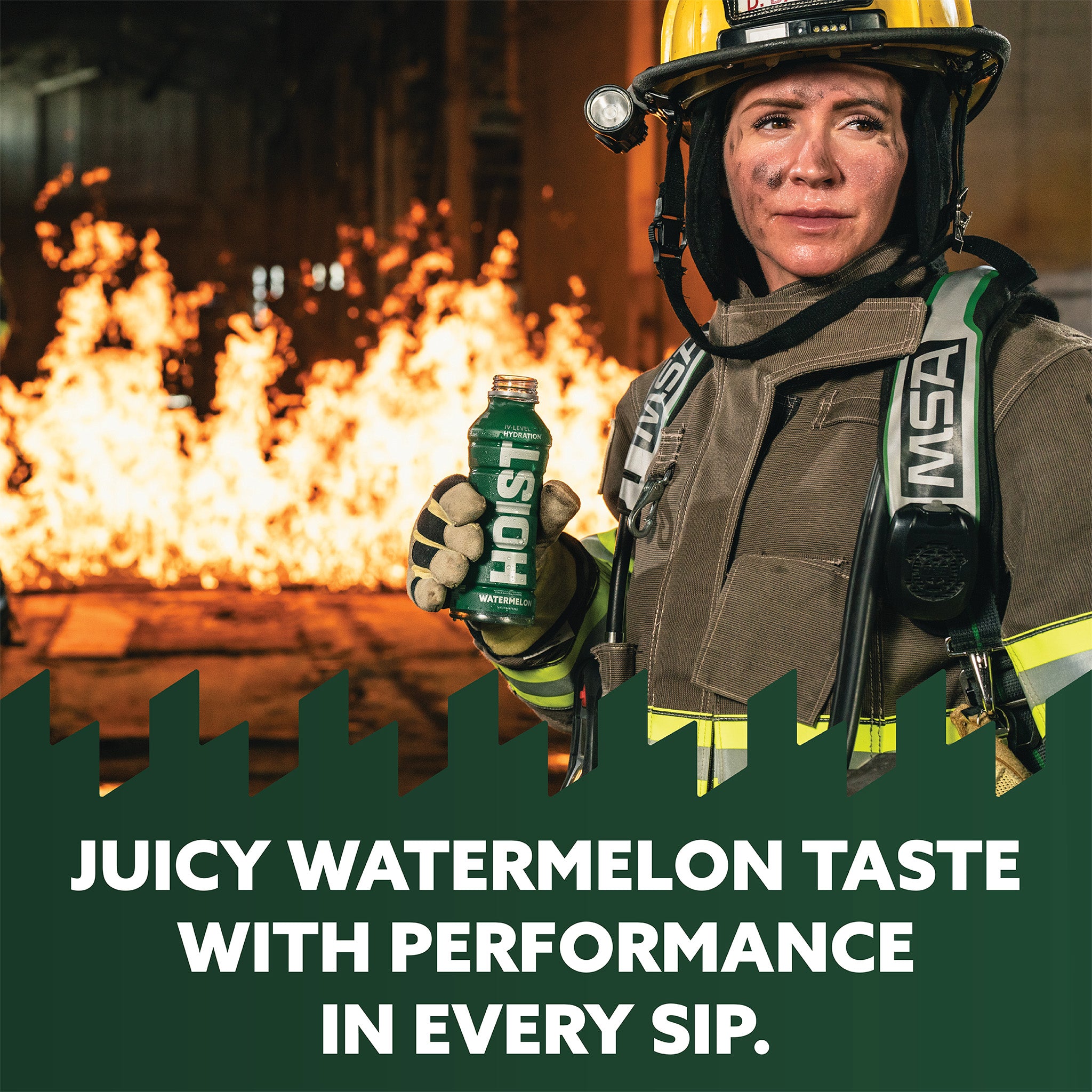Firefighter holding a Hoist energy drink with flames in the background